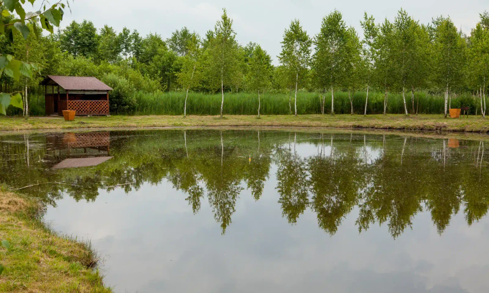 Amazon jungle oxbow lake with a wooden lodge cabin and reflections on the water