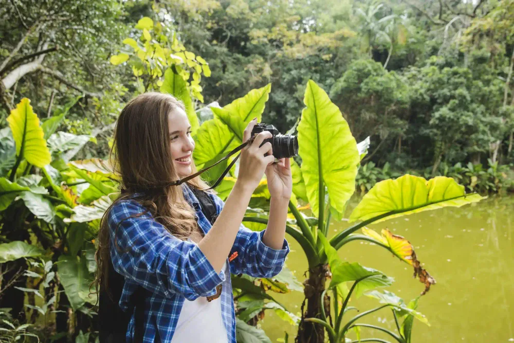 Traveler photographing wildlife among the dense vegetation of the Amazon rainforest
