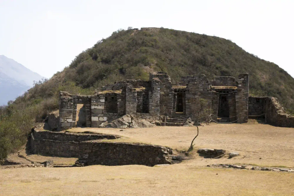 Stone Inca buildings at Choquequirao with the hillside behind on the 4-day trek