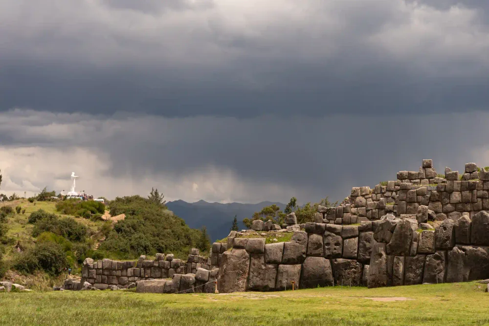 The Sacsayhuamán fortress above Cusco under dramatic Andean skies