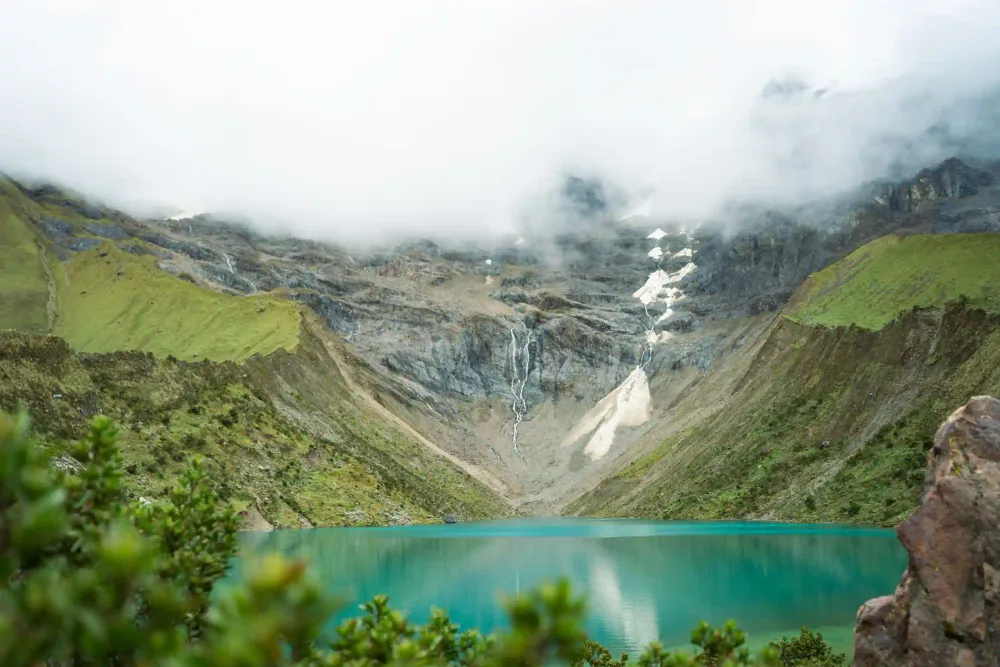 The glacier and waterfall above the turquoise Humantay Lake
