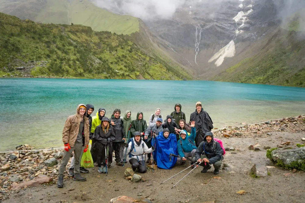 A small group of travelers at Humantay Lake