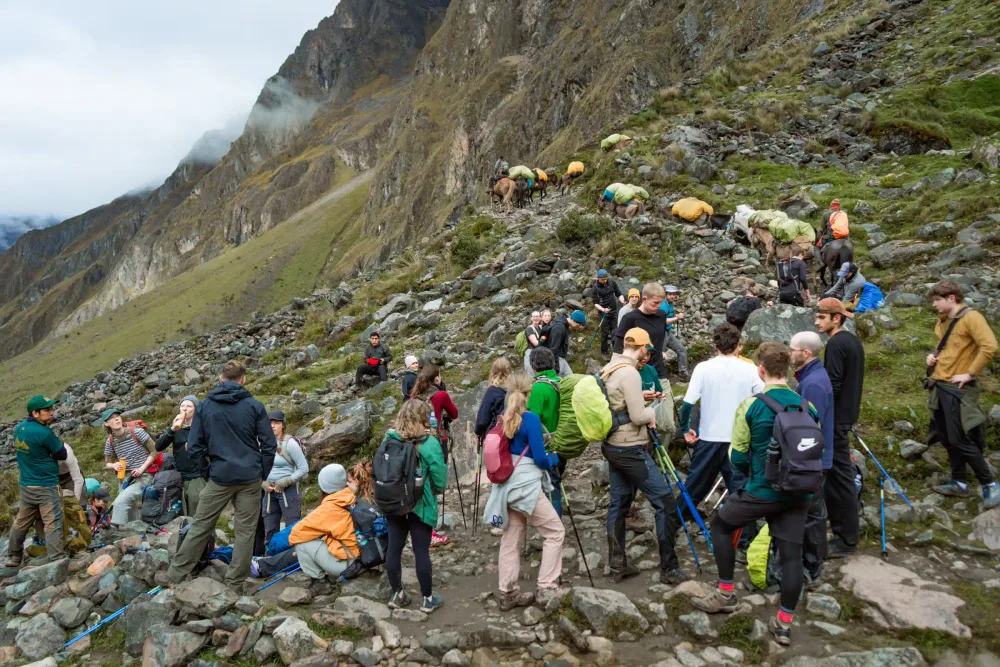 Travelers trekking an Andean mountain trail on the Inca Jungle route to Machu Picchu