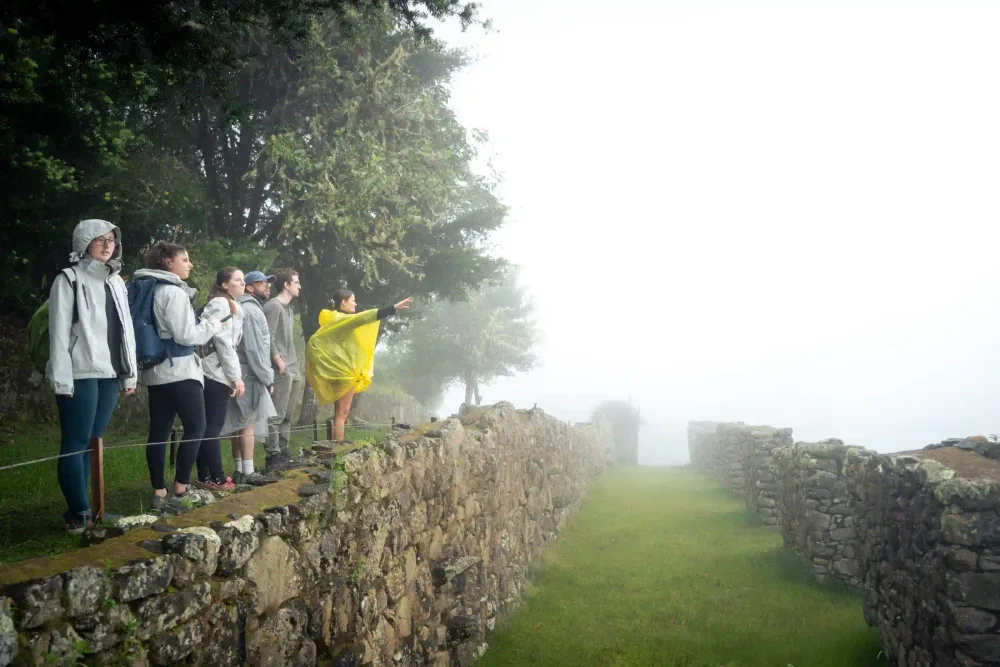 Travelers exploring Machu Picchu with a guide