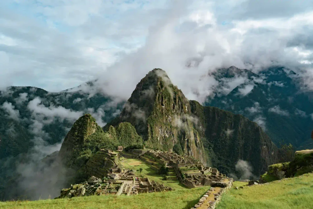 Travelers exploring the Machu Picchu citadel with a guide