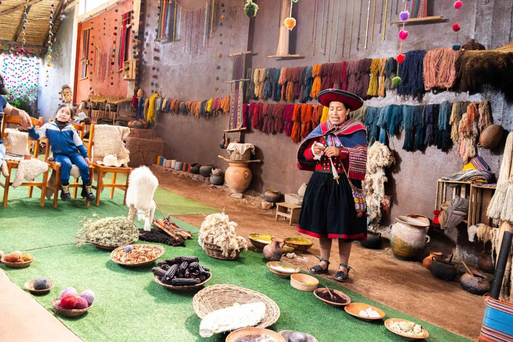 A weaver showing traditional textiles and natural dyes in Chinchero, Sacred Valley